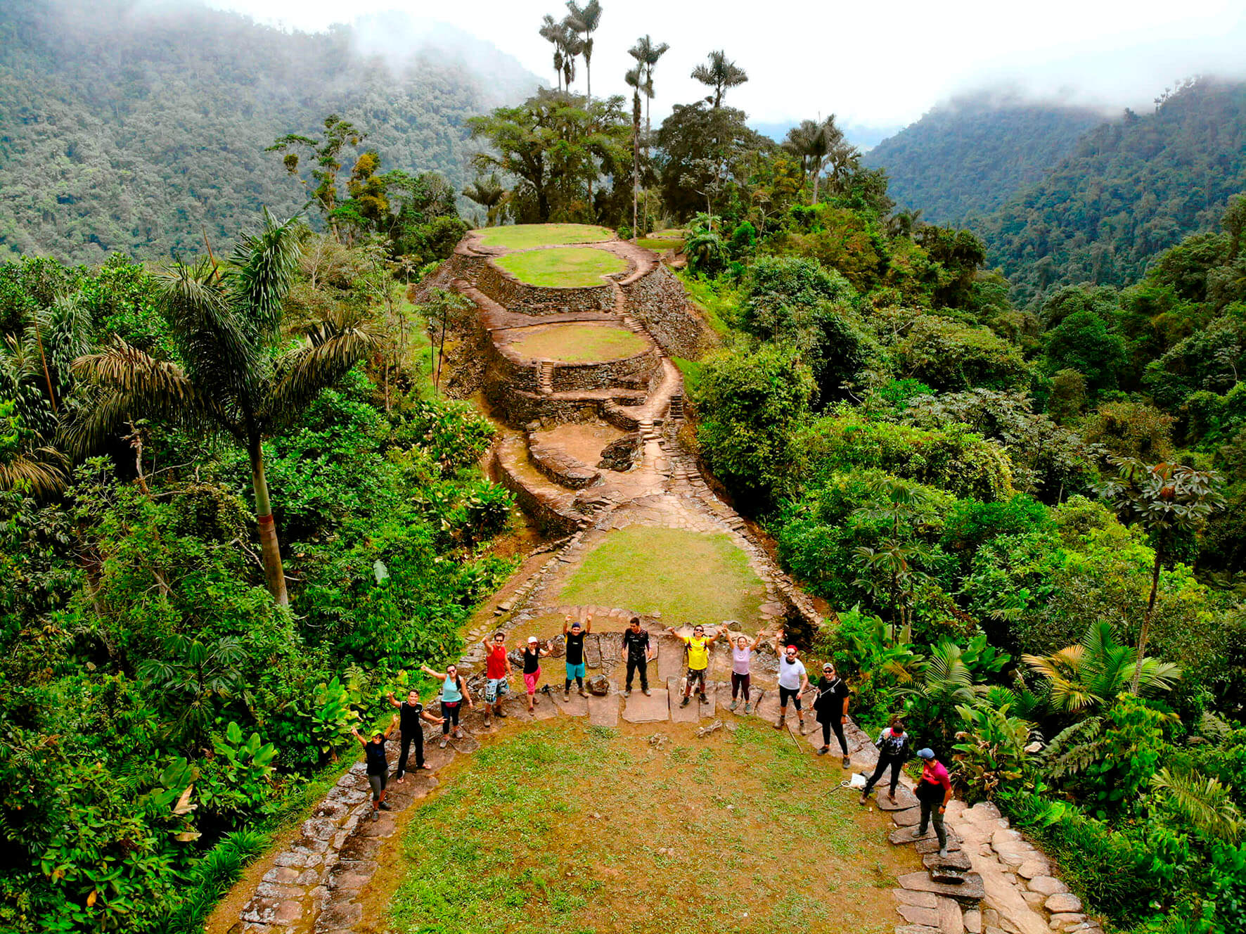 Small group of hikers at viewpoint overlooking Lost City (Teyuna) ruins during 3-day express trek in Colombian jungle